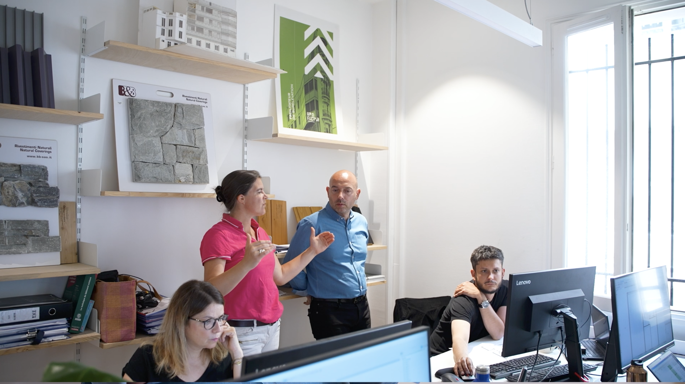 The Upfactor team members are gathered around a building elevation project